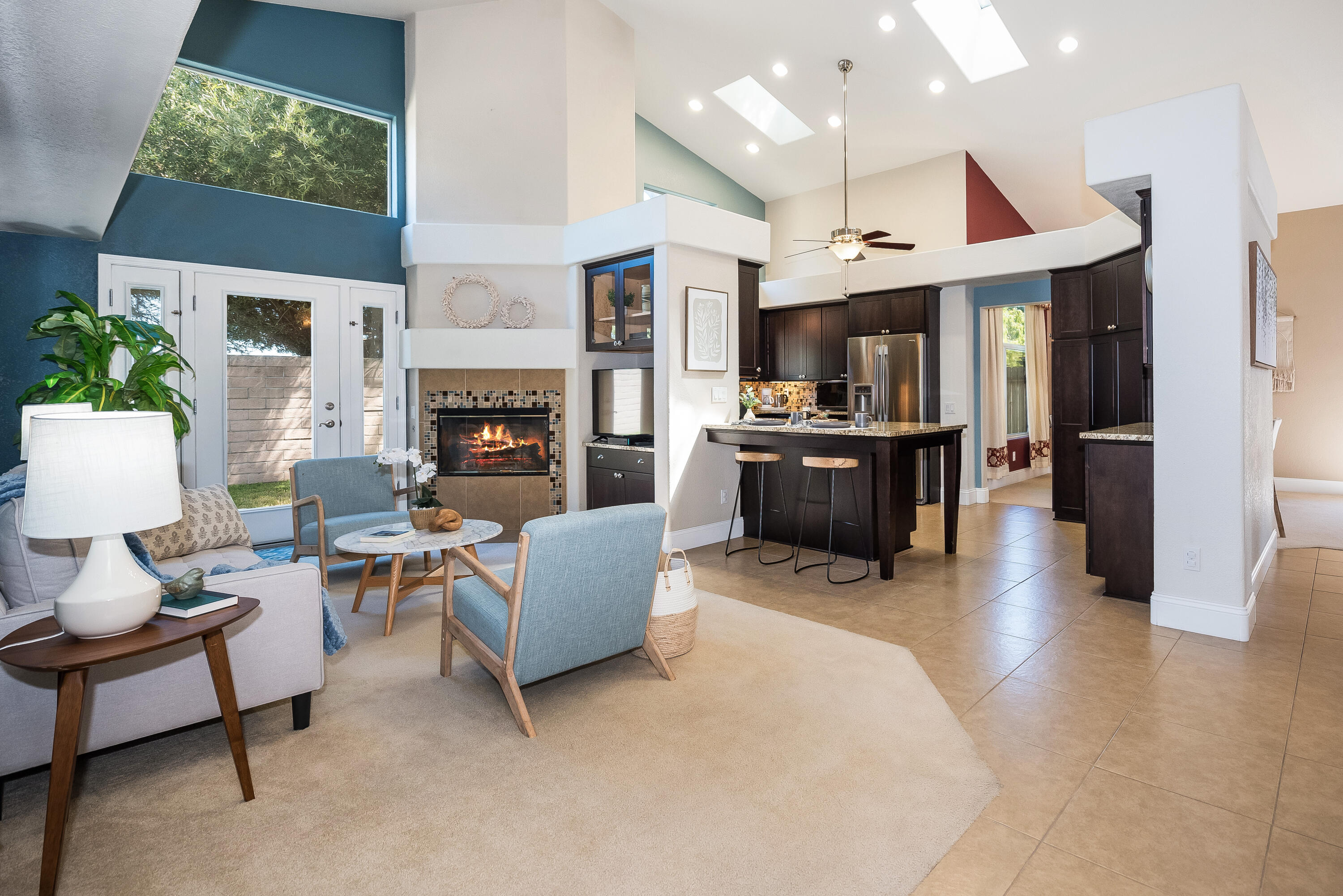 1328 Glen Ellen Lane Lompoc, CA 93436 - Photo 9 of 30 a living room with furniture a fireplace and a kitchen view