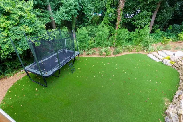 a living room with furniture and a large window with wooden floor
