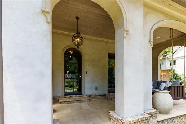 a living room with furniture a fireplace and a large window
