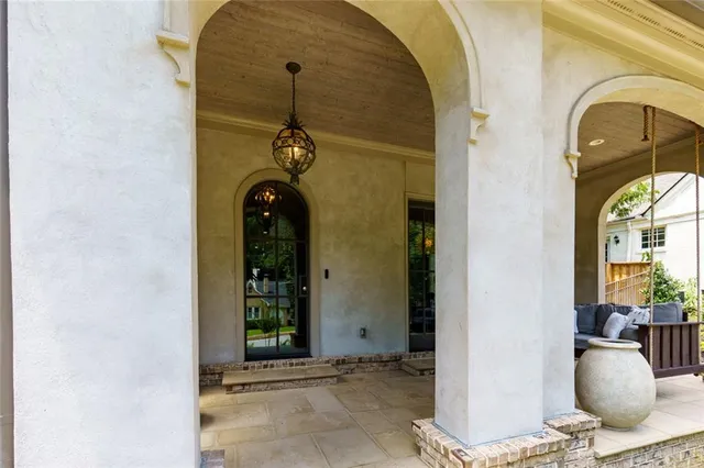 a living room with furniture a fireplace and a large window