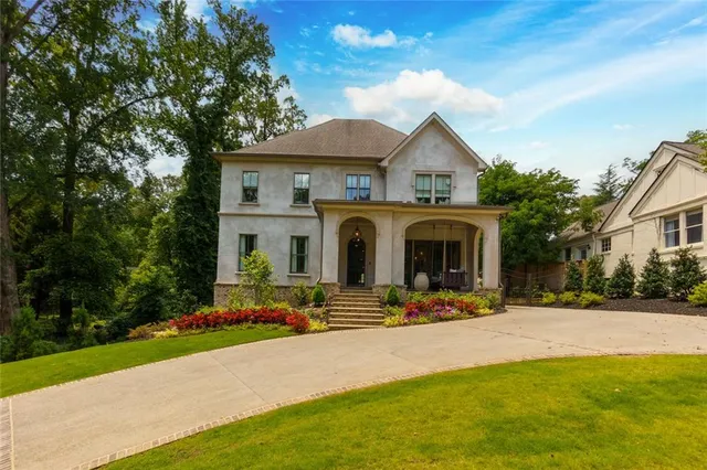 a front view of house with yard and green space
