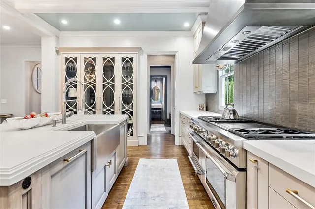 a view of a living room that has a lot of books and white walls