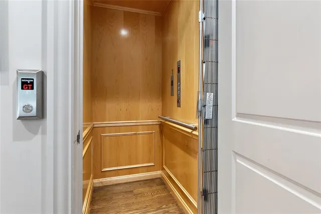 a living room with hard wood floors and a ceiling fan