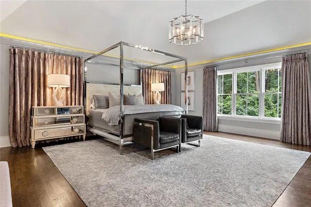 a living room with kitchen furniture and a wooden floor