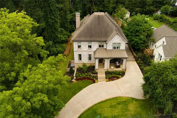 an aerial view of a house with swimming pool and sitting space
