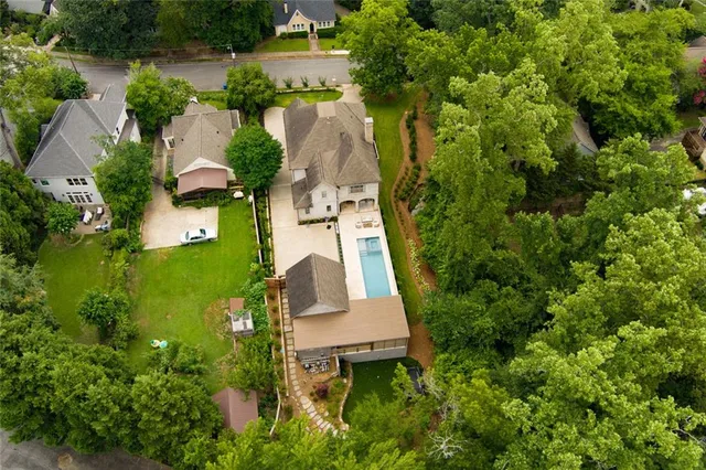 a view of backyard with potted plants and floor to ceiling window