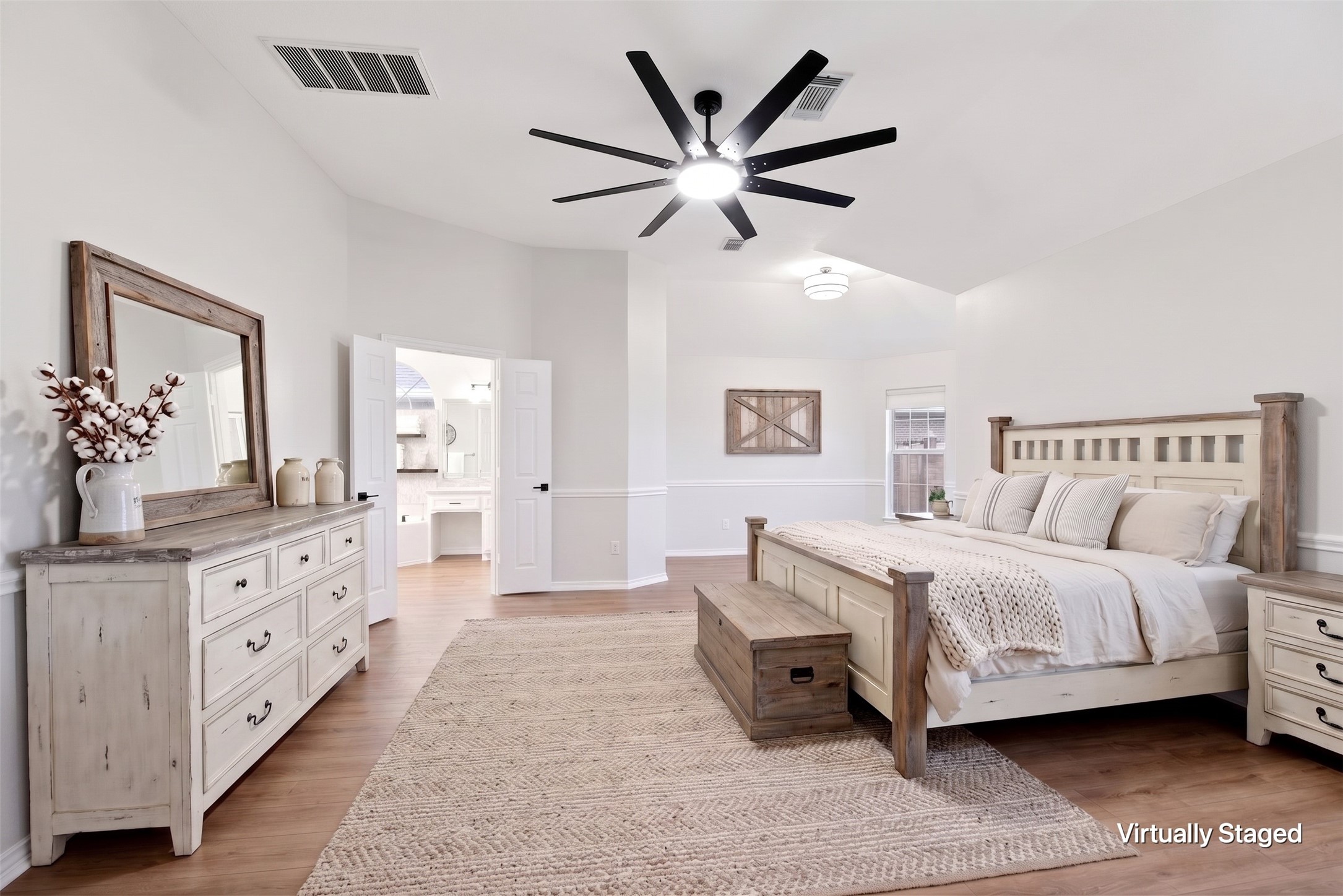 29819 South Legends Village Circle Spring, TX 77386 - Photo 22 of 48 a bedroom with a large bed and a chandelier