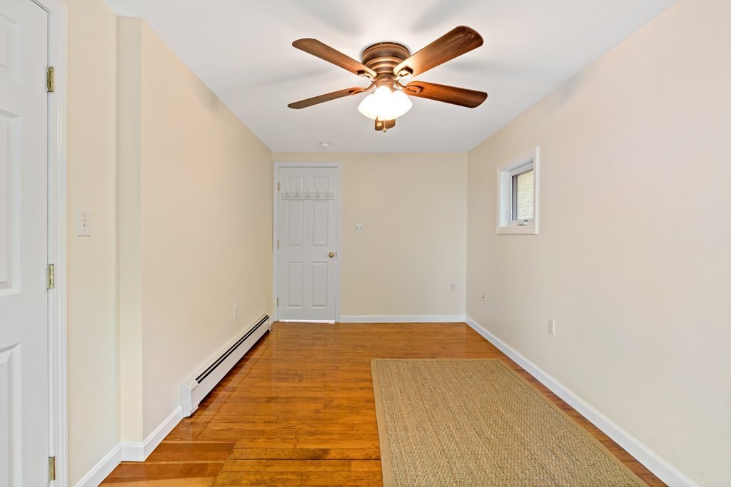 55 Alpine Road Weymouth, MA 02189 - Photo 13 of 31 an empty room with a ceiling fan and wooden floor