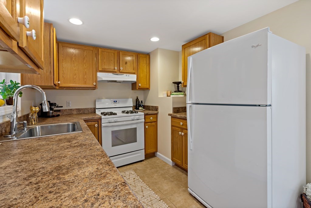 55 Alpine Road Weymouth, MA 02189 - Photo 14 of 31 a kitchen with a refrigerator sink stove and cabinets