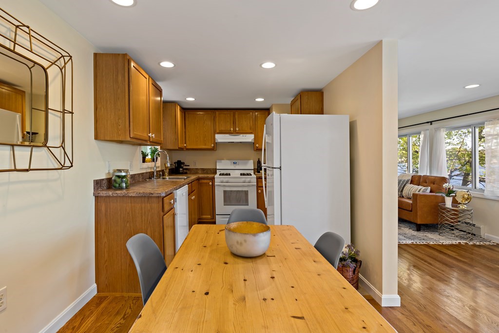 55 Alpine Road Weymouth, MA 02189 - Photo 23 of 31 a kitchen with sink a refrigerator and cabinets