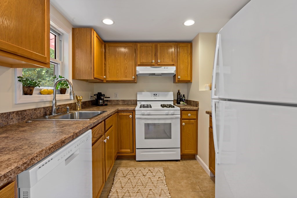 55 Alpine Road Weymouth, MA 02189 - Photo 25 of 31 a kitchen with a sink a stove top oven and cabinets