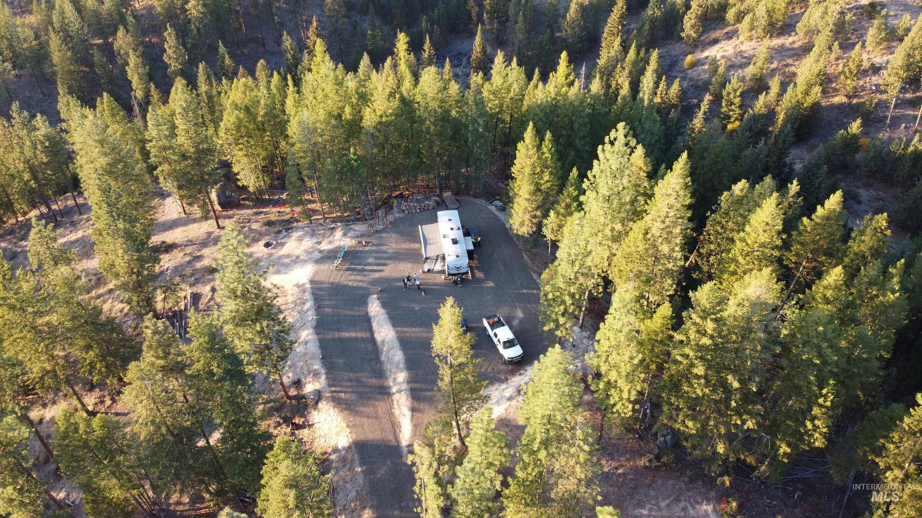 Aerial overview of property's location featuring a heavily wooded area