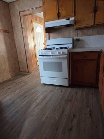 a kitchen with wooden floors and a stove
