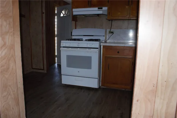 a stove top oven sitting inside of a kitchen