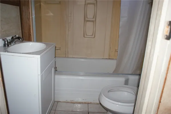 a bathroom with a sink a toilet and tub