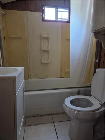 a white toilet sitting next to a shower