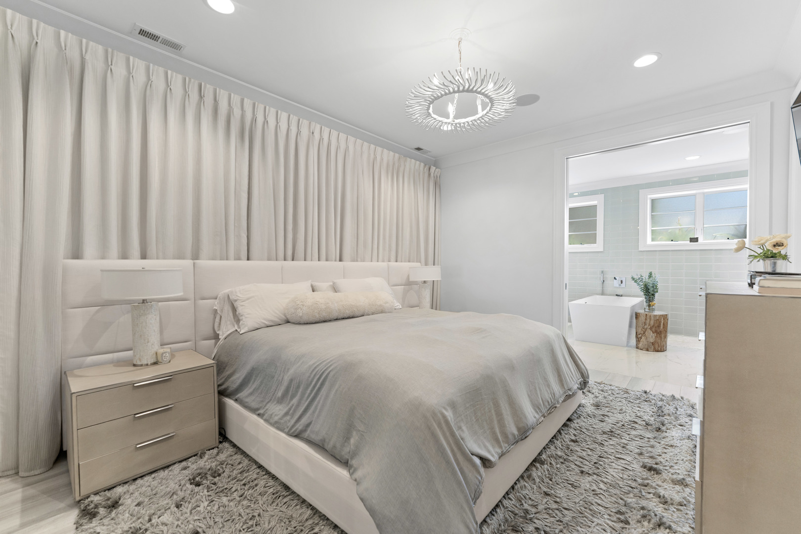 2040 North Burling Street, Unit 1 Chicago, IL 60614 - Photo 18 of 29 a bedroom with a bed and a chandelier