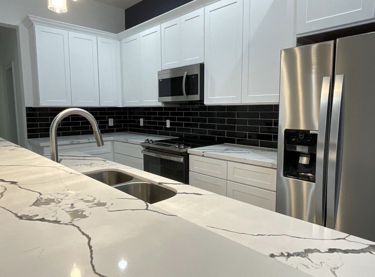5202 Northridge Drive, Unit B Houston, TX 77033 - Photo 2 of 12 a kitchen with stainless steel appliances kitchen island a refrigerator sink and cabinets