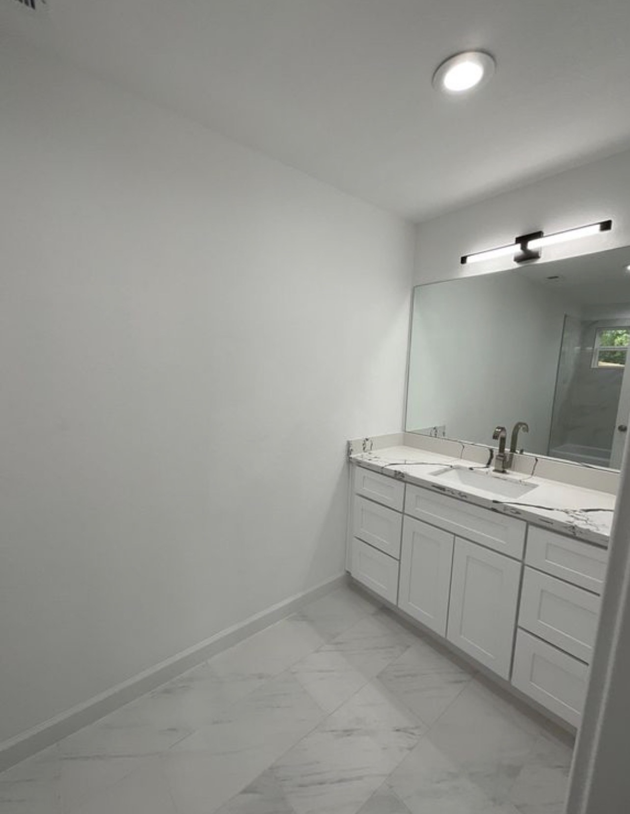 5202 Northridge Drive, Unit B Houston, TX 77033 - Photo 9 of 12 a bathroom with 2 sink and a mirror