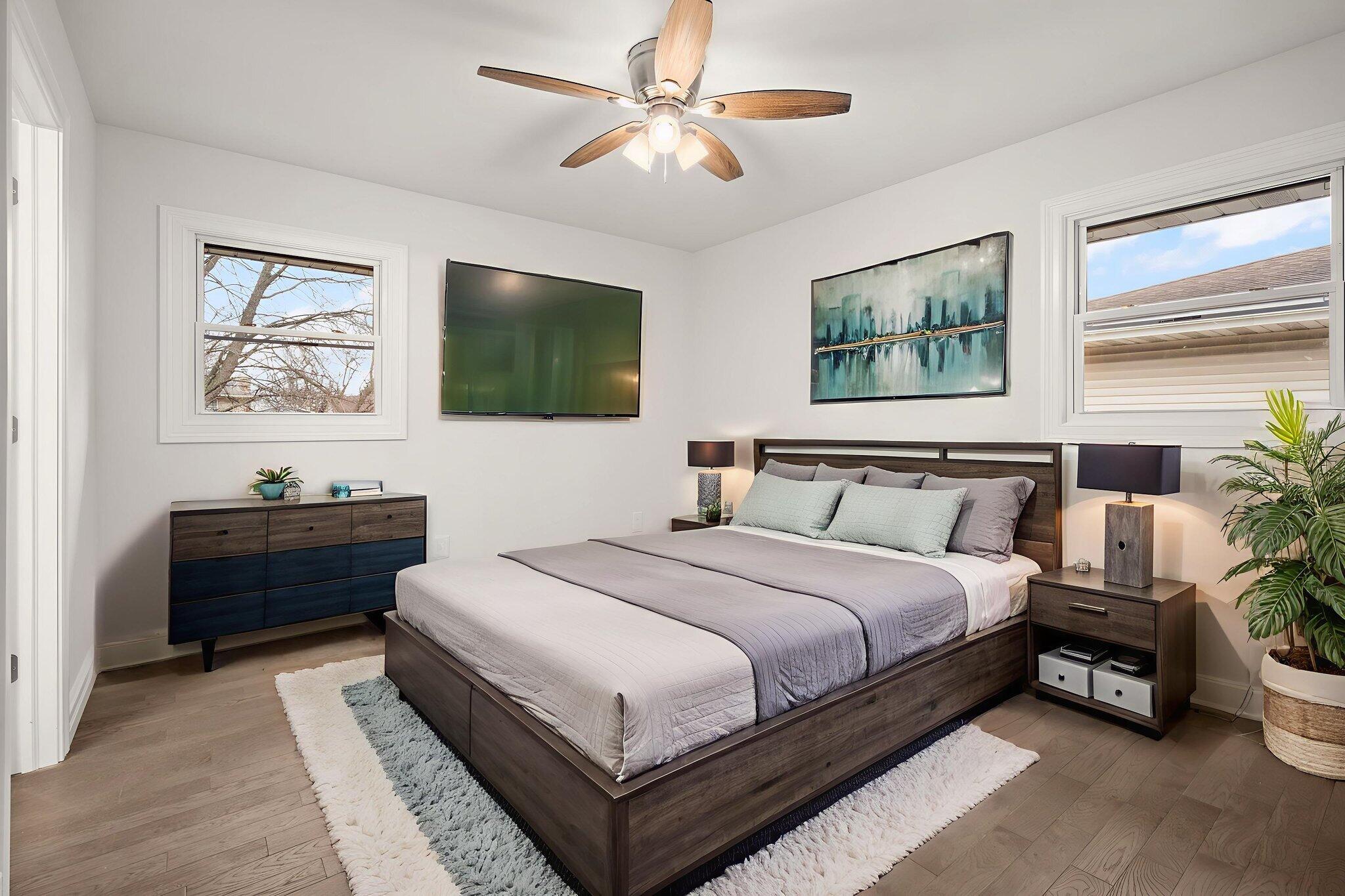 8749 Monroe Avenue Munster, IN 46321 - Photo 13 of 33 a spacious bedroom with a bed and a flat screen tv