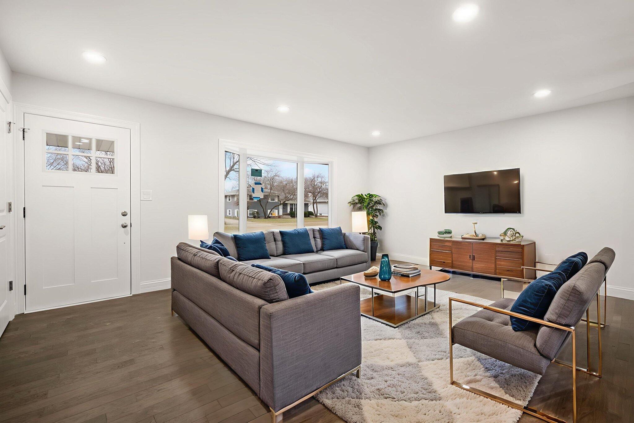 8749 Monroe Avenue Munster, IN 46321 - Photo 7 of 33 a living room with furniture and a flat screen tv