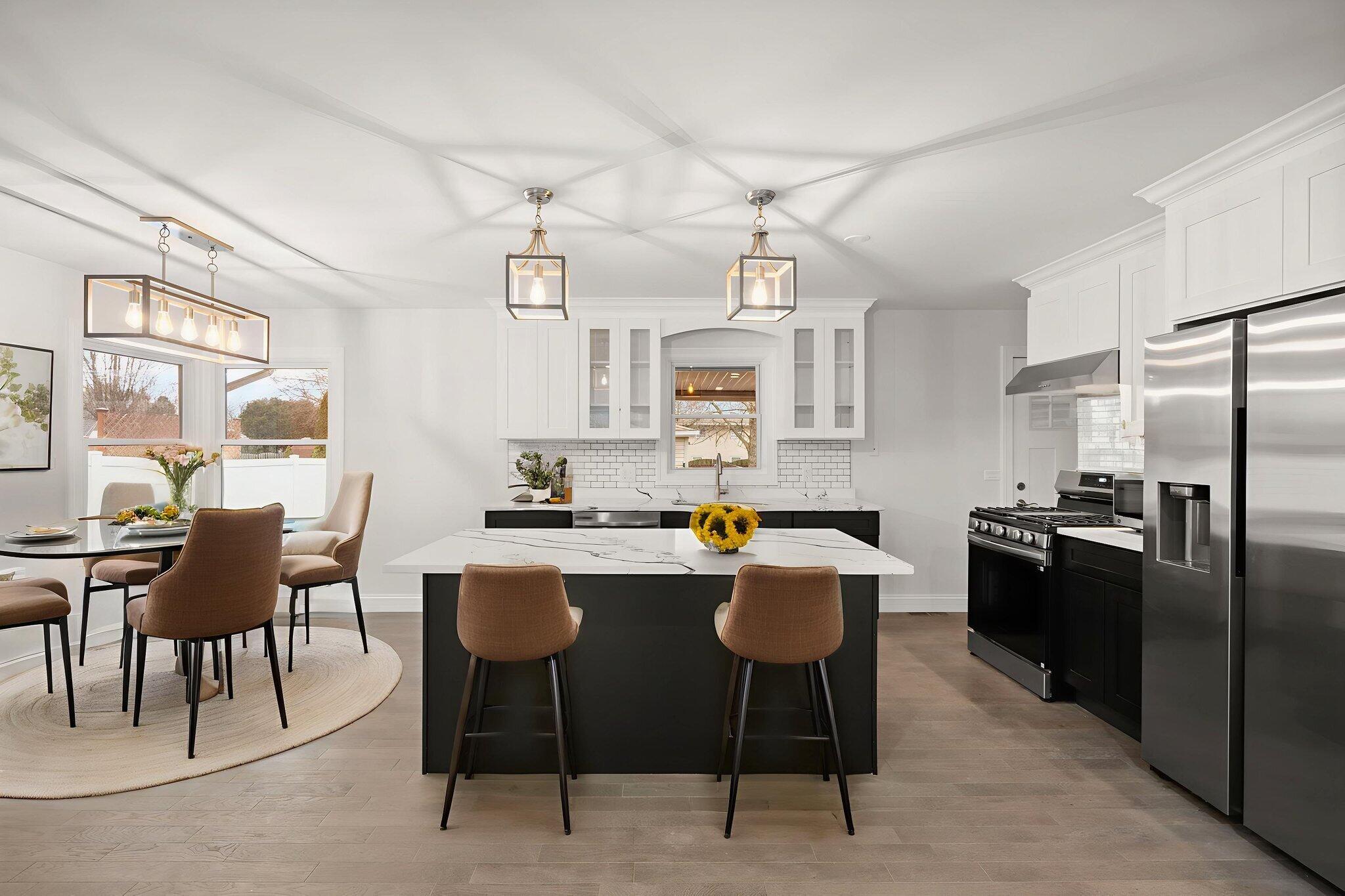 8749 Monroe Avenue Munster, IN 46321 - Photo 8 of 33 a kitchen with stainless steel appliances kitchen island granite countertop a table chairs and a refrigerator