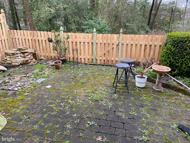 a view of a backyard with chairs and a garden