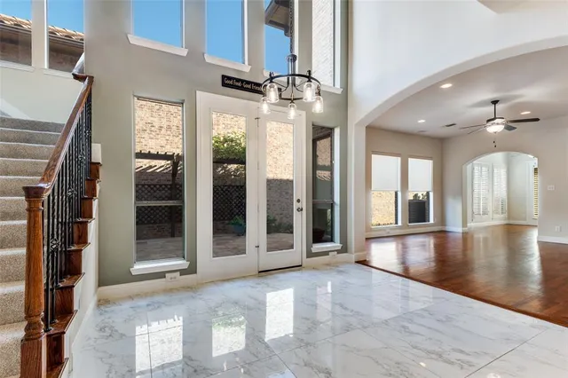 a view of an entryway with a floor to ceiling windows and a living room