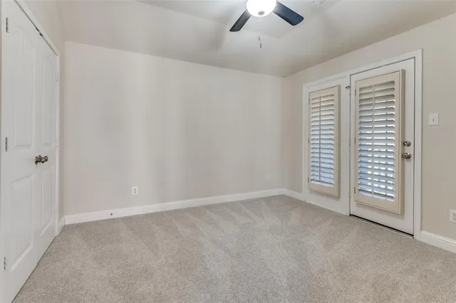 an empty room with chandelier fan