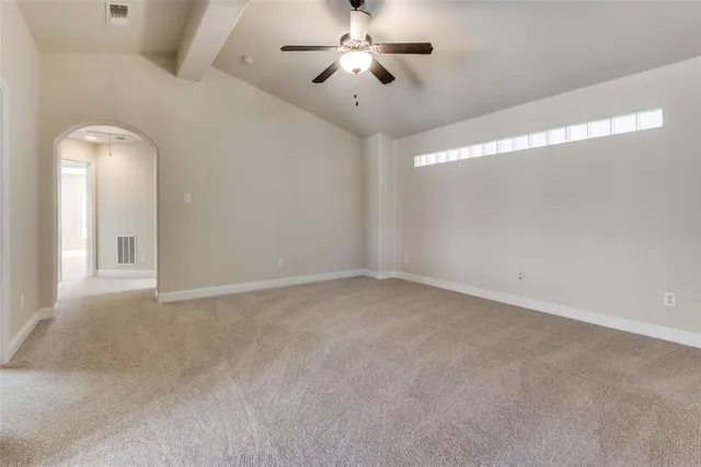 a view of a room with ceiling fan and window
