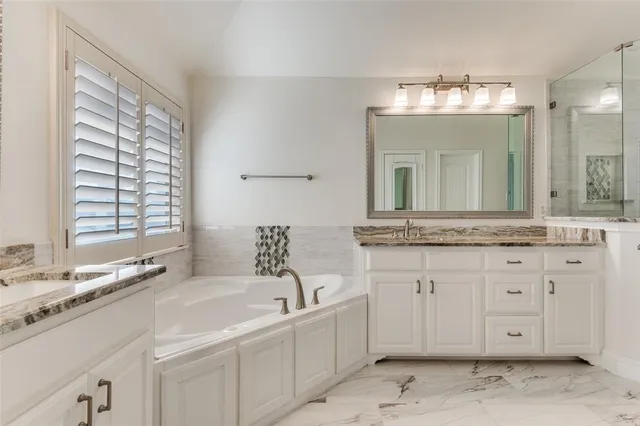 a bathroom with a sink vanity and mirror