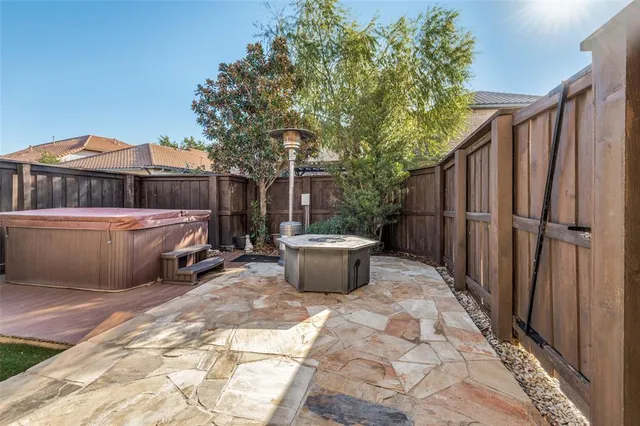 a view of a backyard with wooden fence and floor