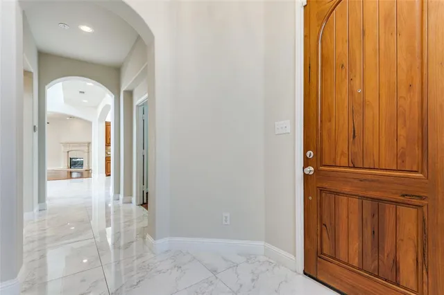 a view of a hallway with wooden floor and entryway