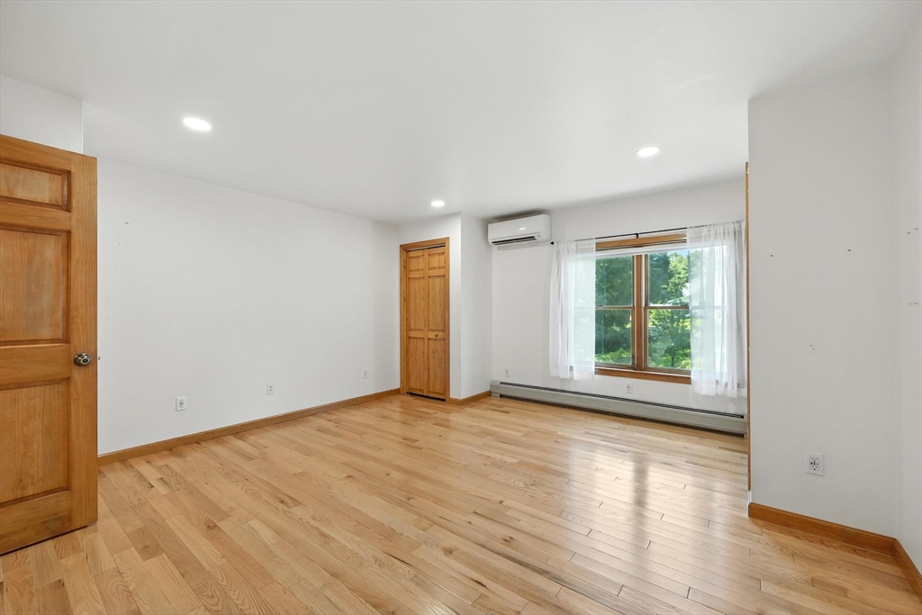 17 Glendale Road Southampton, MA 01073 - Photo 29 of 42 an empty room with wooden floor and windows