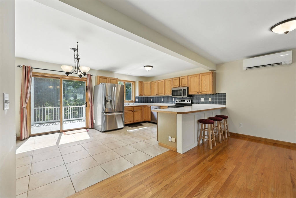 17 Glendale Road Southampton, MA 01073 - Photo 7 of 42 a view of kitchen with stainless steel appliances granite countertop a stove top oven a sink dishwasher and a dining table with wooden floor