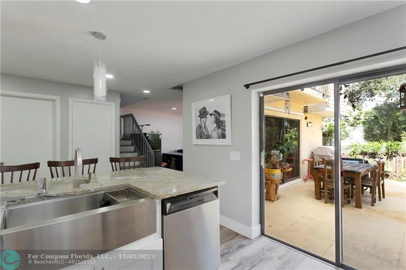 2929 Southwest 22nd Circle, Unit 32B Delray Beach, FL 33445 - Photo 12 of 22 a view of kitchen island a refrigerator and a sink