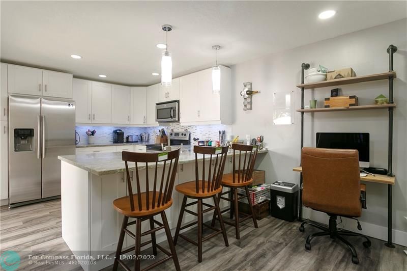 2929 Southwest 22nd Circle, Unit 32B Delray Beach, FL 33445 - Photo 13 of 22 a view of kitchen with cabinets table and chairs