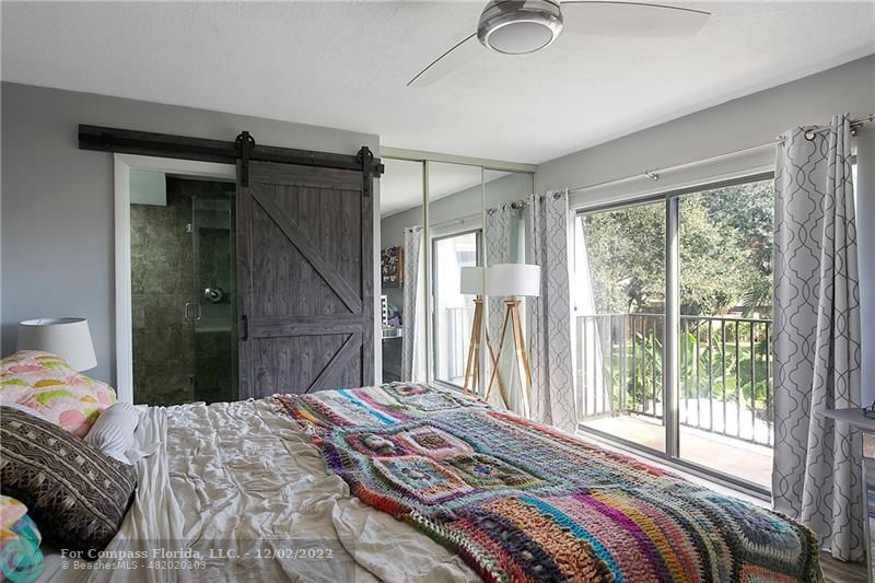 2929 Southwest 22nd Circle, Unit 32B Delray Beach, FL 33445 - Photo 16 of 22 a bedroom with a bed and a large window