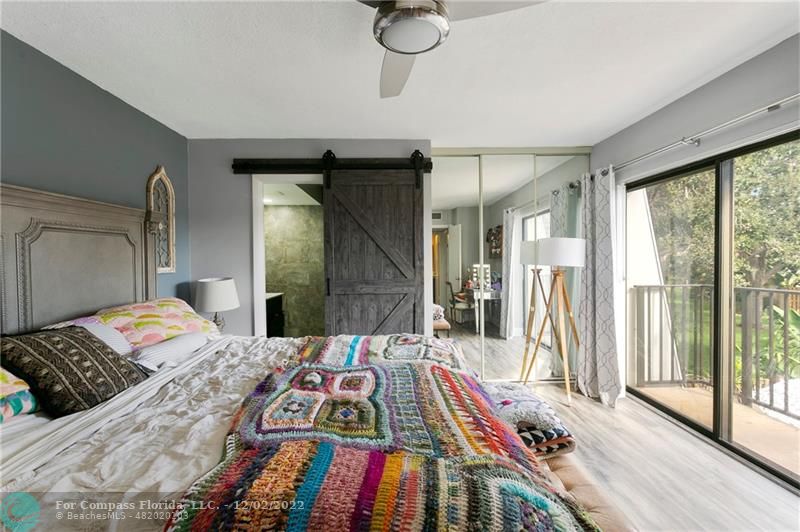 2929 Southwest 22nd Circle, Unit 32B Delray Beach, FL 33445 - Photo 17 of 22 a bedroom with a bed and a large window