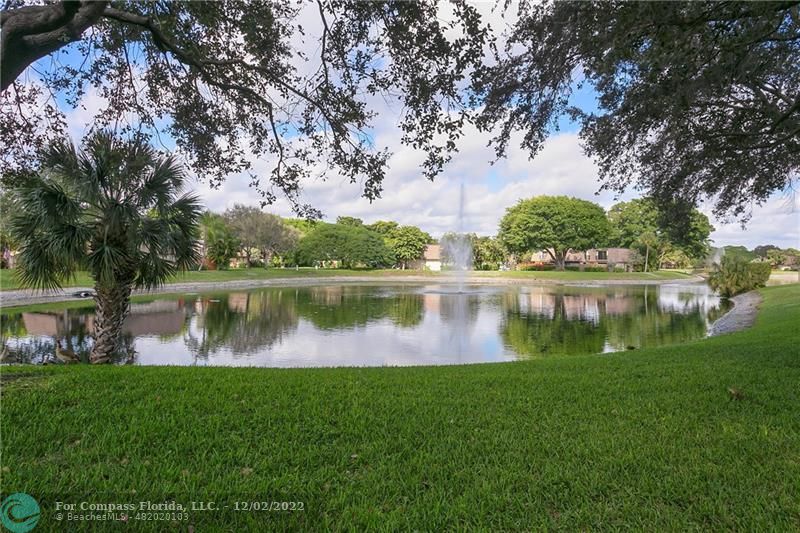 2929 Southwest 22nd Circle, Unit 32B Delray Beach, FL 33445 - Photo 3 of 22 a view of a lake with a house in the background