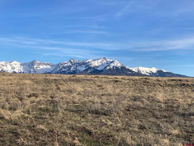 a view of a large building with mountains in the background