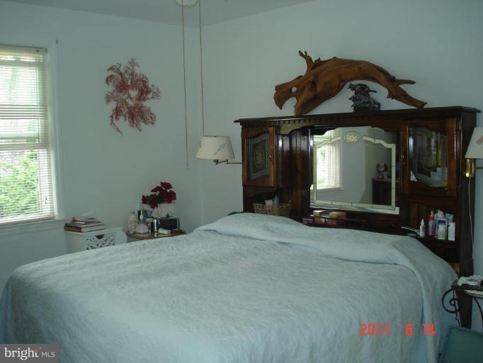 3317 Offutt Road Randallstown, MD 21133 - Photo 12 of 13 a bedroom with a bed and window