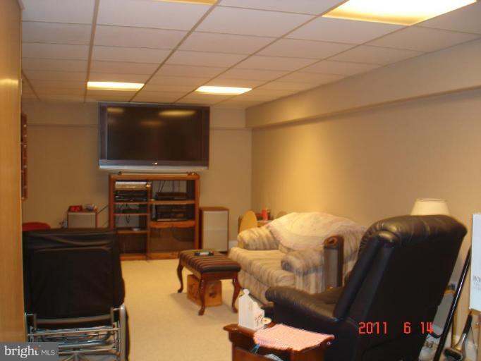 3317 Offutt Road Randallstown, MD 21133 - Photo 5 of 13 a living room with furniture and a flat screen tv