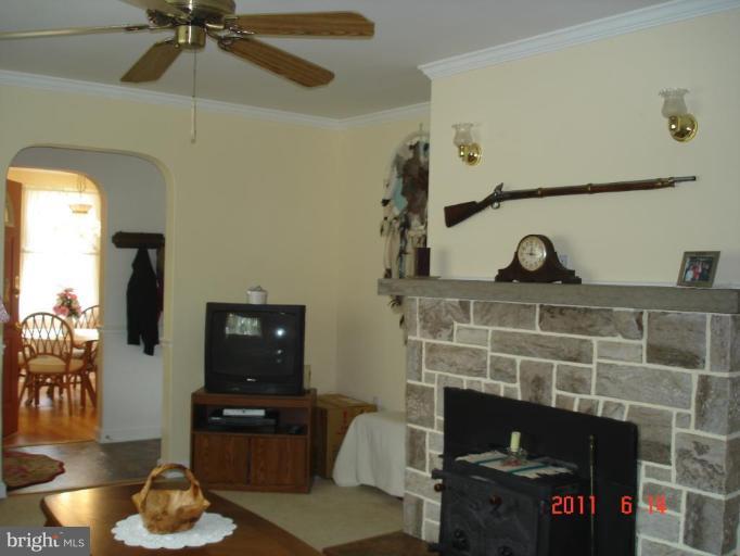 3317 Offutt Road Randallstown, MD 21133 - Photo 7 of 13 a living room with furniture and a fireplace