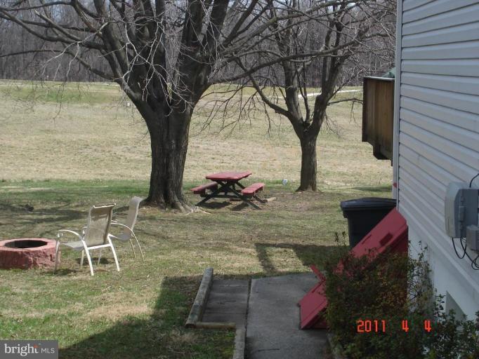 3317 Offutt Road Randallstown, MD 21133 - Photo 9 of 13 a view of a patio with table and chairs and potted plants