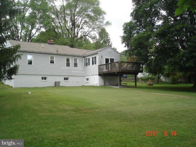3317 Offutt Road Randallstown, MD 21133 - Photo 10 of 13 a view of a house with a big yard and large trees