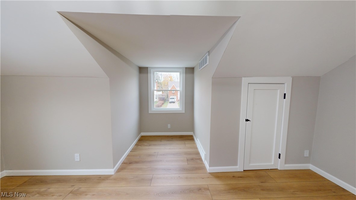5252 Spencer Road Cleveland, OH 44124 - Photo 22 of 33 Bonus room with light wood-type flooring and vaulted ceiling