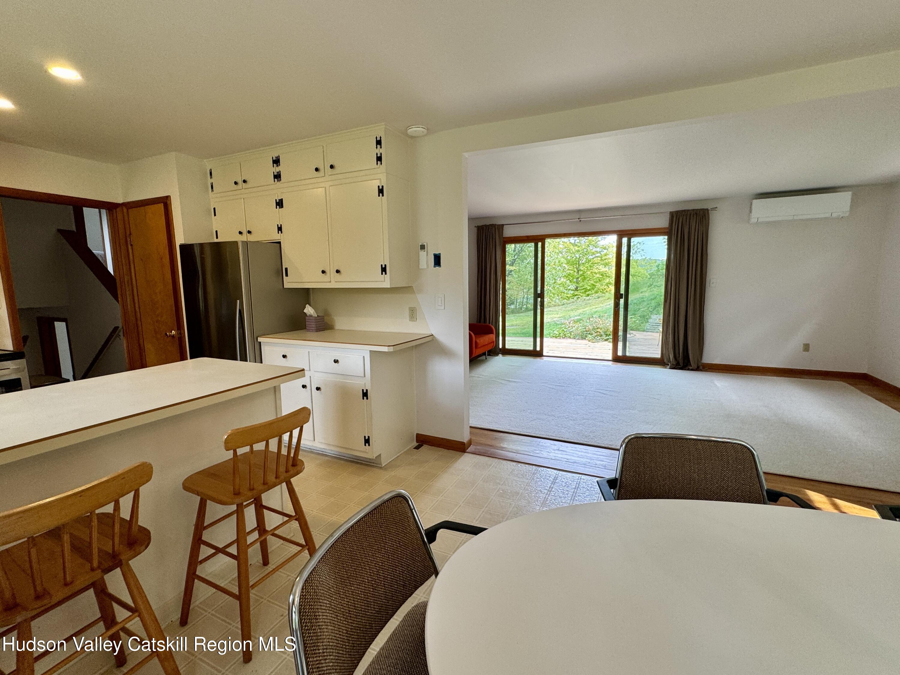 399 Hamburg Road Catskill, NY 12414 - Photo 11 of 23 a living room with stainless steel appliances furniture a large window and a refrigerator