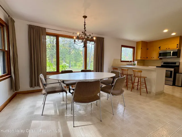 a room with a window sink and mirror