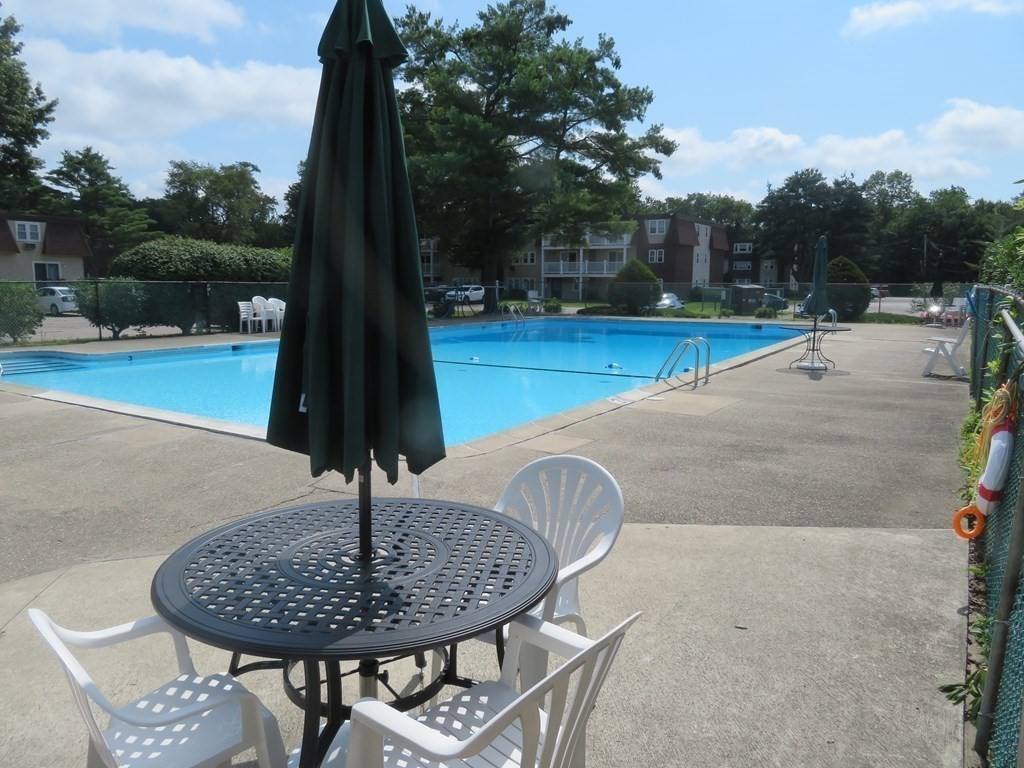 180 Main Street, Unit B32 Bridgewater, MA 02324 - Photo 3 of 6 a swimming pool with a bench in the background